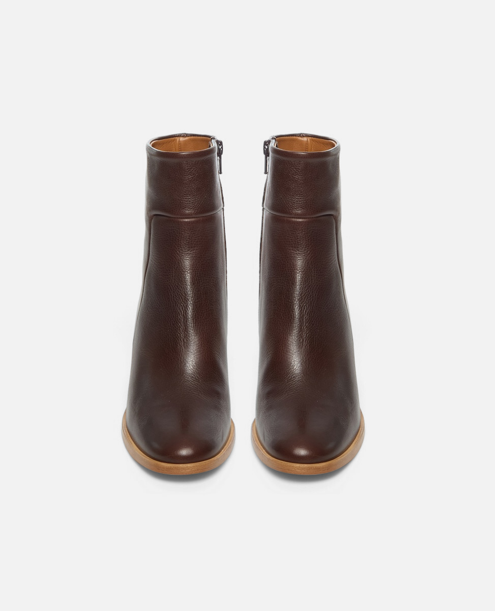 Pair of brown leather ankle boots on a white background