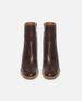 Pair of brown leather ankle boots on a white background 3
