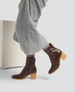 Brown ankle boots with wooden heel on a light gray background 5