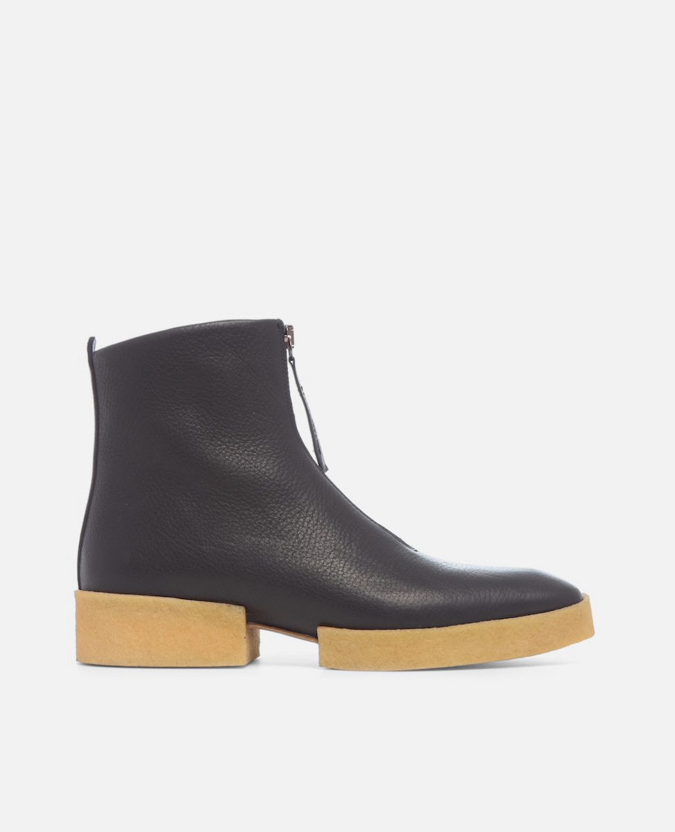 Black ankle boot with a wooden sole on a white background