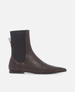 Brown leather ankle boot with black side panel on a white background 1