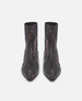 Pair of black pointed-toe boots on a white background 2