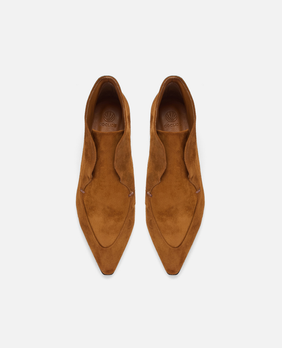 Pair of brown suede shoes on a white background