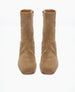 A pair of tan suede ankle boots with a smooth texture, square toes, and side zippers, featuring a minimalist design and a medium-height stacked heel. 7