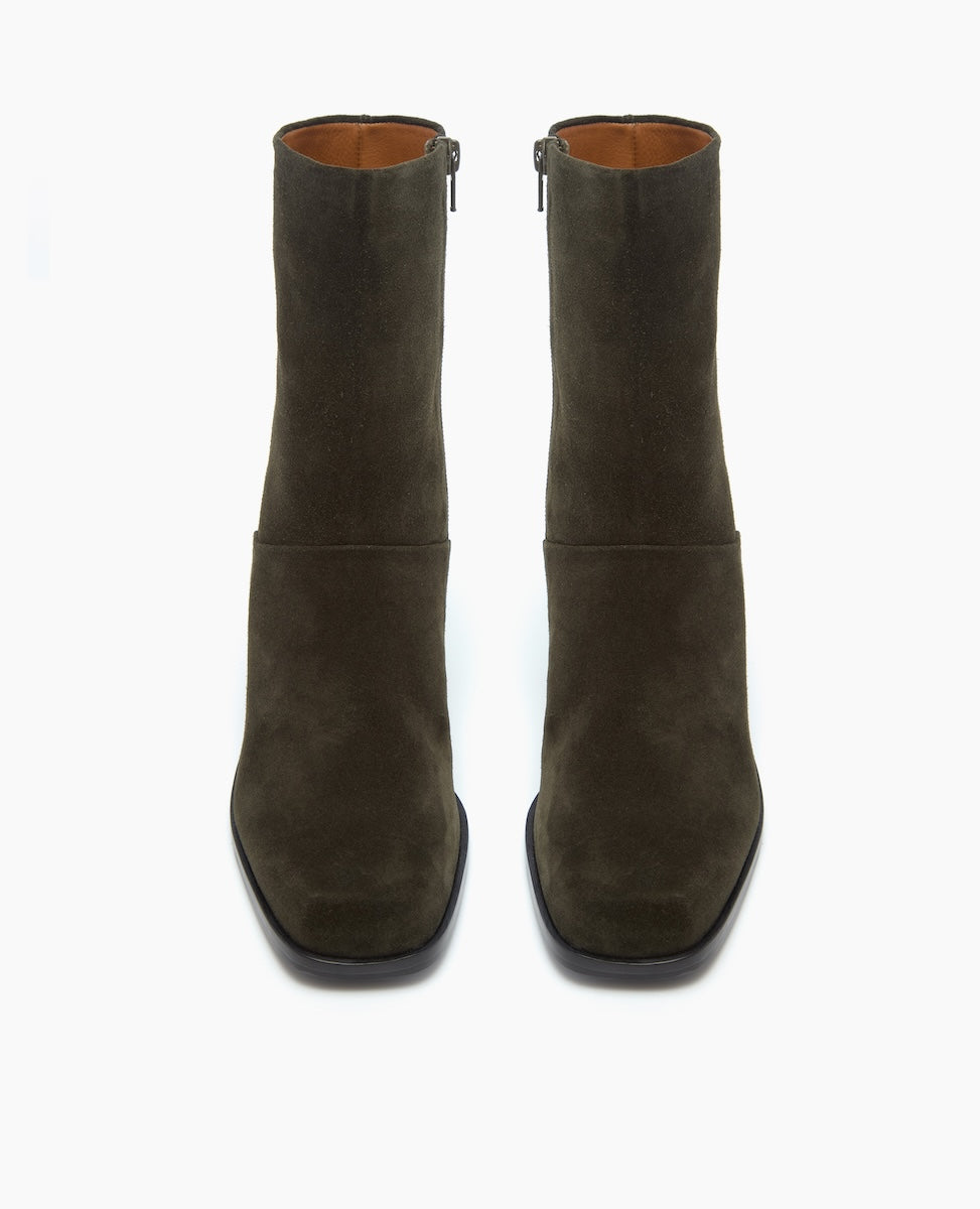 A pair of olive green, mid-calf suede boots with a square toe, side zippers, and a smooth, matte finish.
