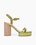Side view of  Angel platform sandal makes a statement in chartreuse patent leather featuring a single strap across the toes is paired with a clean quarter strap and a covered buckle.  1