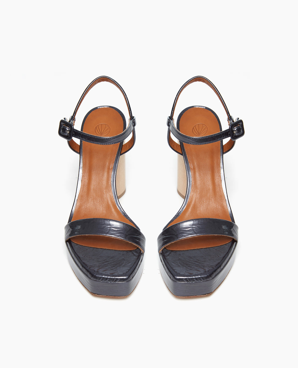 Front view of the Angel Platform in Italian black pearl leather. With a 90mm solid wood heel and a 25mm wrapped recycled cork platform.
