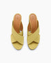 These sandals feature a mustard yellow color with wide, crisscrossing leather straps, an open toe design, a tan insole with branding, and a low, flat sole. 5