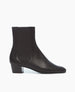 Side view of the Coclico Celeste Boot in black leather: a sleek, mid-heel Chelsea boot with leather-covered gore. 1