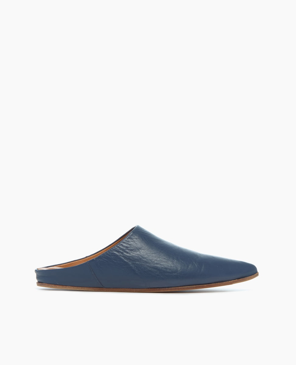 A sleek, blue leather slipper with a pointed toe, flat sole, and smooth texture.