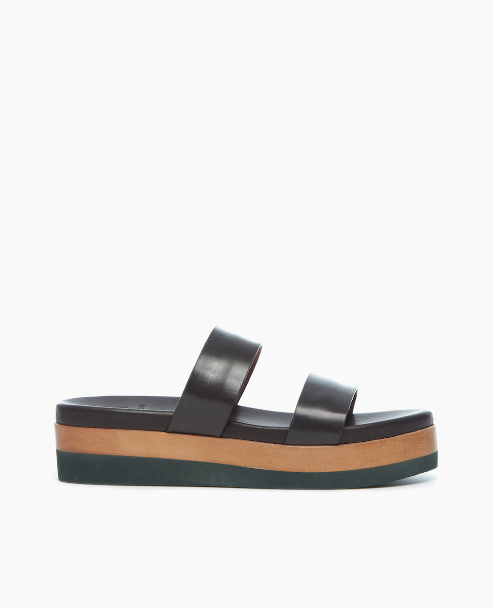 Angled view of the Dawn Wedge; an easy two-strap slide upper sits atop a molded footbed and an ultra-lightweight EVA platform unit. 
