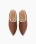 Brown, pointed-toe slippers with a soft, plush interior lining, featuring a smooth leather-like exterior and a cozy, slip-on design. 7