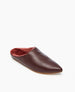 A brown leather slipper with a pointed toe, featuring a soft pink fur lining and a flat sole. 4