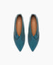 A pair of teal, pointed-toe leather flats with a smooth texture and a subtle seam detail along the top, featuring a tan insole with a logo imprint. 4