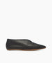 A sleek, black leather slip-on shoe with a pointed toe, smooth texture, and a thin brown sole. 3