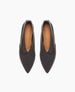 Sleek black leather flats with a pointed toe, smooth texture, and a subtle V-shaped cut at the vamp, featuring a tan insole with a logo imprint. 5