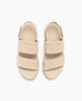 Beige sandals with a smooth, matte finish feature two wide straps across the top, a rounded open toe, a slingback strap with a buckle, and a slightly elevated sole. 6