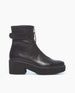 A sleek, black leather ankle boot with a smooth texture, featuring an EVA platform heel, a rounded toe, a front zipper, and a leather strap around the ankle. 2