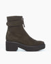 A dark olive green suede ankle boot with a light black EVA platform heel, an operational front zipper, and a strap around the ankle. 5