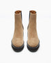 Tan suede ankle boots with a smooth texture, black elastic side panels, a rounded toe, and a black EVA sole. 8