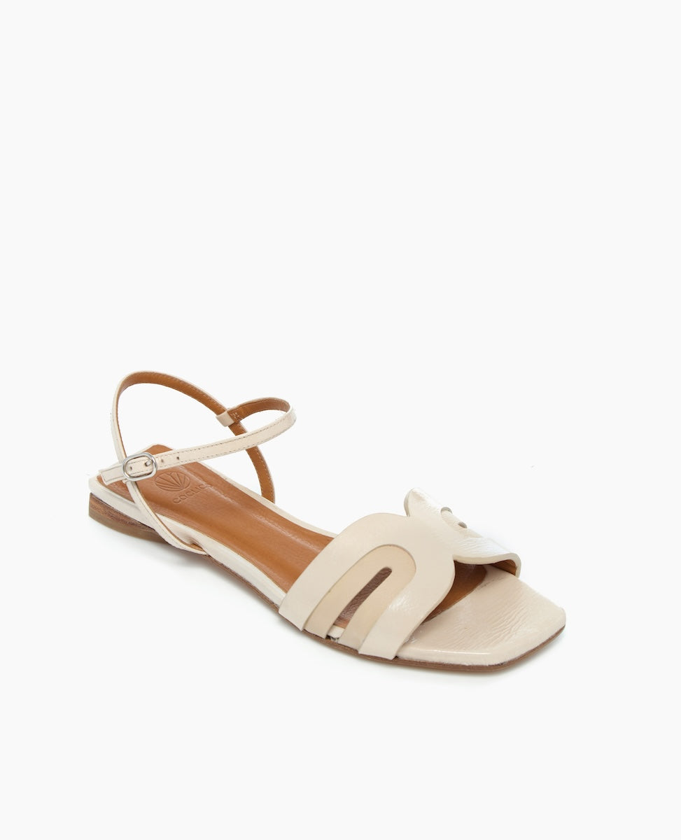 angled view of White Sandals with arched strap and buckle closure