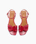 Red sandals with a glossy finish feature a unique cut-out design on the front strap, an adjustable ankle strap, and a tan insole with a logo imprint. 5