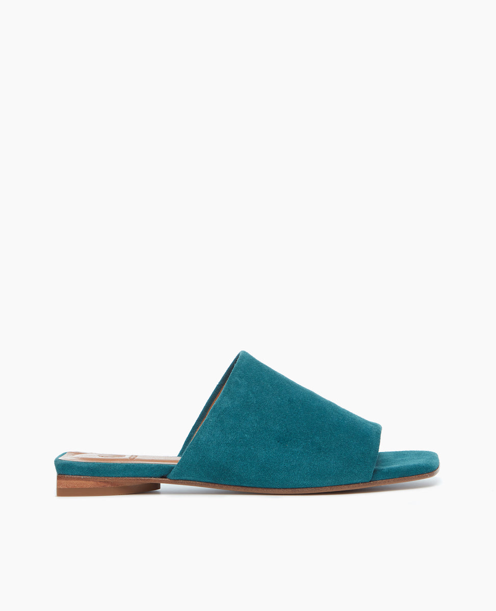 Side view of the Ferhana Sandal in azure split suede designed to hug the foot with a stacked leather heel, perfect for all day everyday wear.
