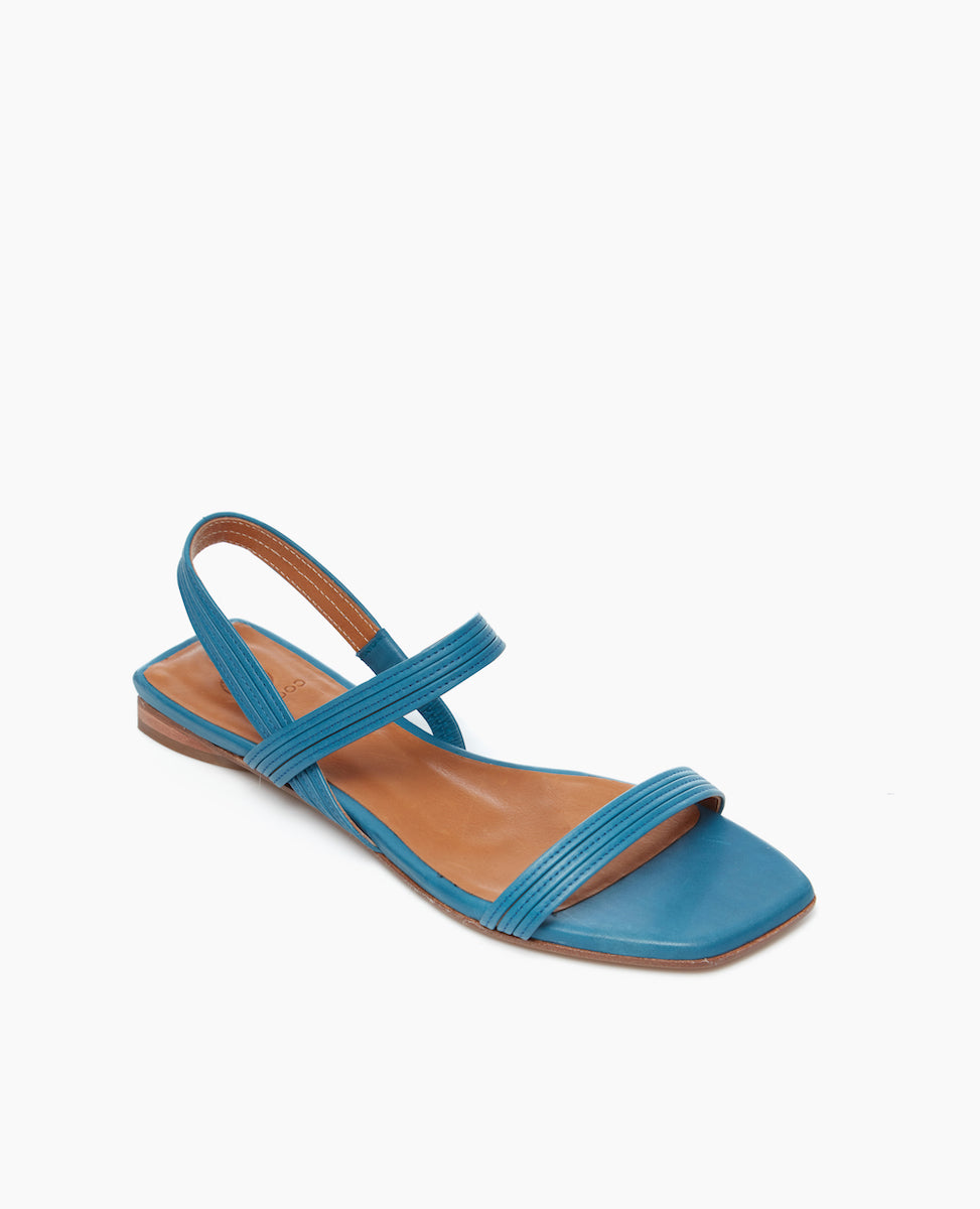 Angled view of the Fifi Sandal in Cerulean leather with barely there string like straps and a 10mm sandal. 