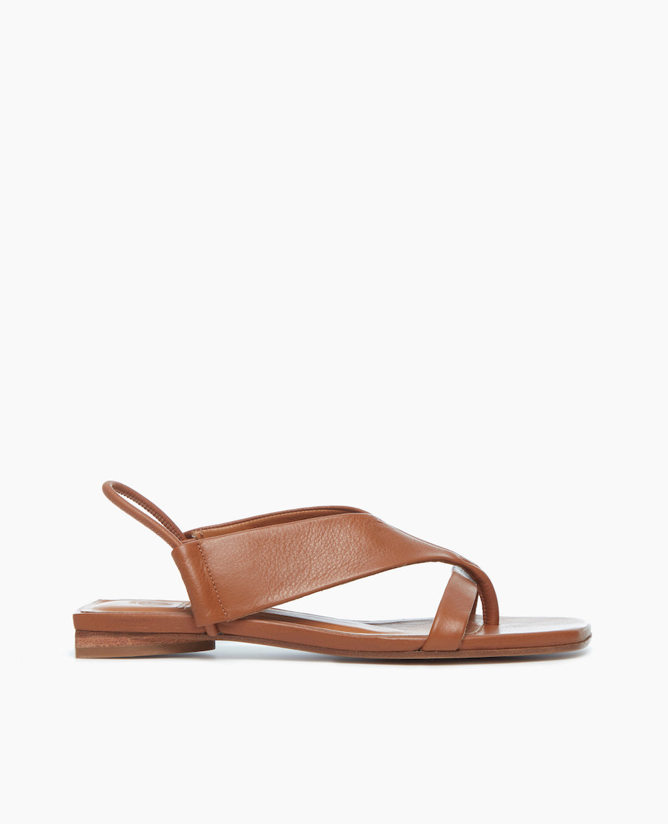 Side view of the Finch Sandal in Cuoio, featuring a wide-strap thong and elasticized leather strap at the heel.