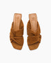 Brown suede sandals with a twisted knot design, featuring a square open toe and a flat sole, displaying a soft, textured finish and a branded insole. 5