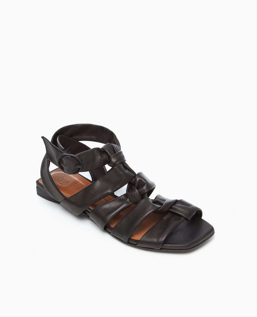 Angled view of the Flair Gladiator Sandal in Black with soft straps that pair perfectly with the strenght of the squared-off toe and heel. 
