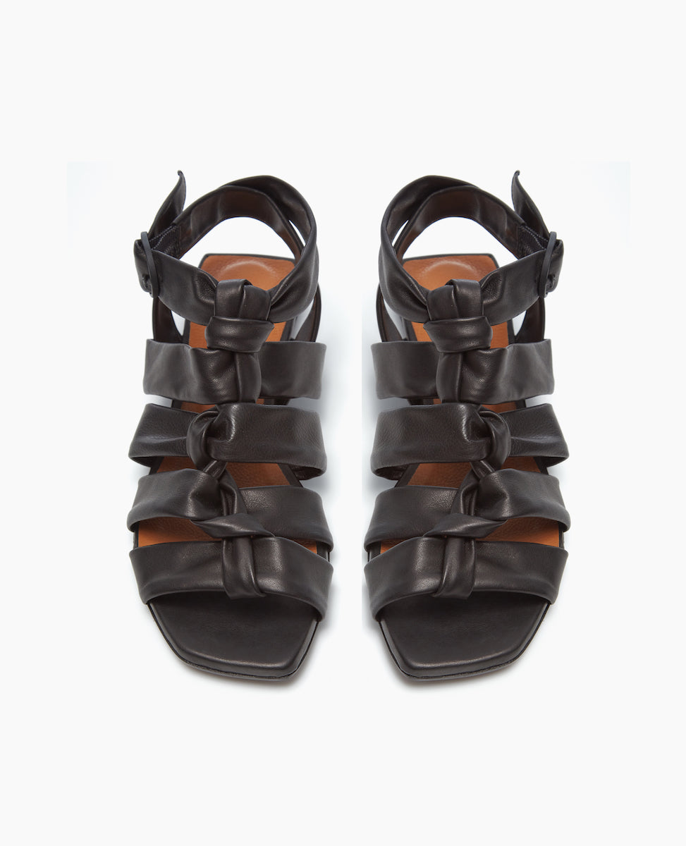 Front view of the Gladiator Sandal in Black, featuring the softest, tubular leather straps that twist upward and are paired perfectly with the strenght of the squared-off toe and heel. 
