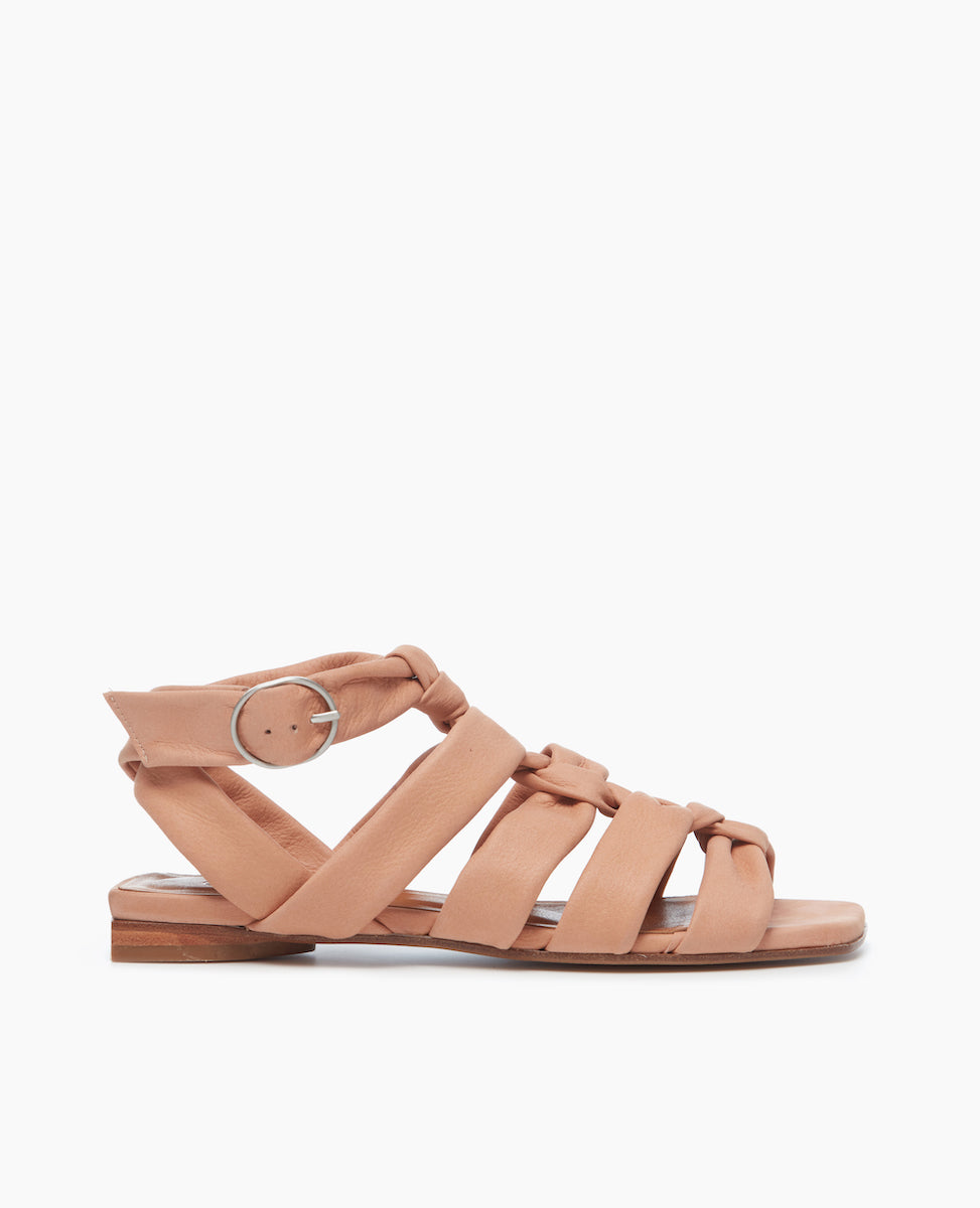 Side view of the Flair Gladiator Sandal in Fawn featuring the softest, tubular leather straps that twist upward and are secured at the ankle by a buckle fastening.