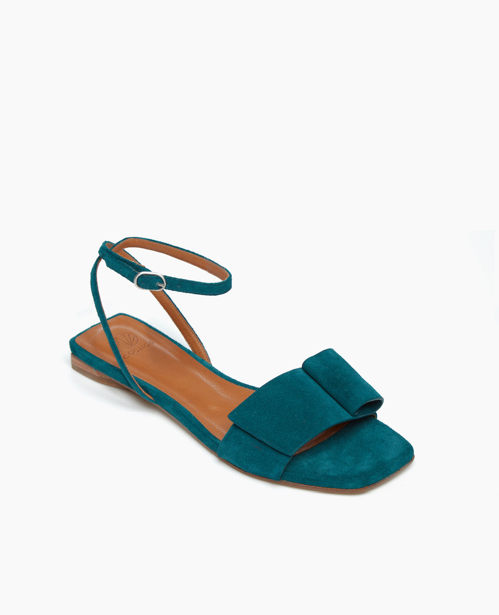 Angled view of the Frances Sandal in Azure with an architectural loop and fastened at the ankle with a slim strap and buckle closure. Squared-off toe and heel for a crisp, modern look.