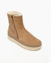 A tan suede ankle boot with a side zipper, featuring a thick, cream-colored rubber sole and a plush, fleece-lined interior. 3