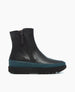 A sleek, black leather ankle boot with a side zipper, featuring a contrasting teal midsole and a thick, textured black rubber sole. 2