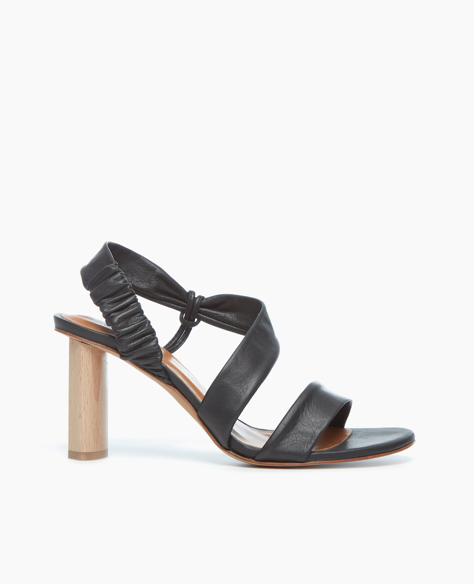 Side view of the Gabby Heel in Deep Sea, featuring soft, tubular straps that mold to the foot, one diagonally over the arch in a leg-lengthening magic trick.