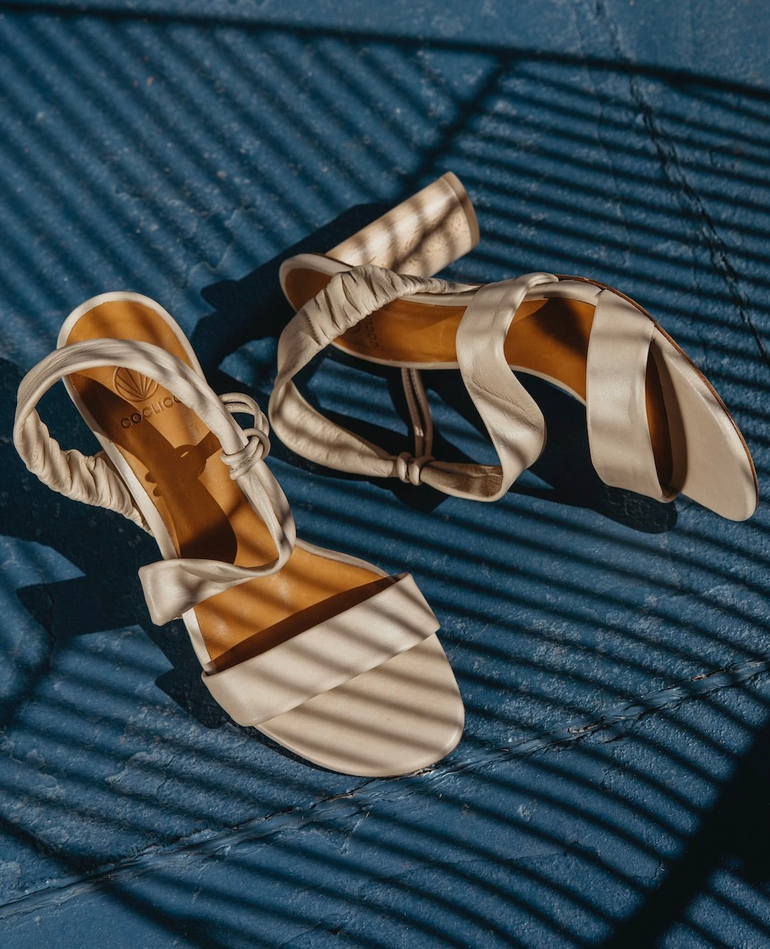 Above view of the Gabby Heel in Latte Macchiato against concrete flooring. 