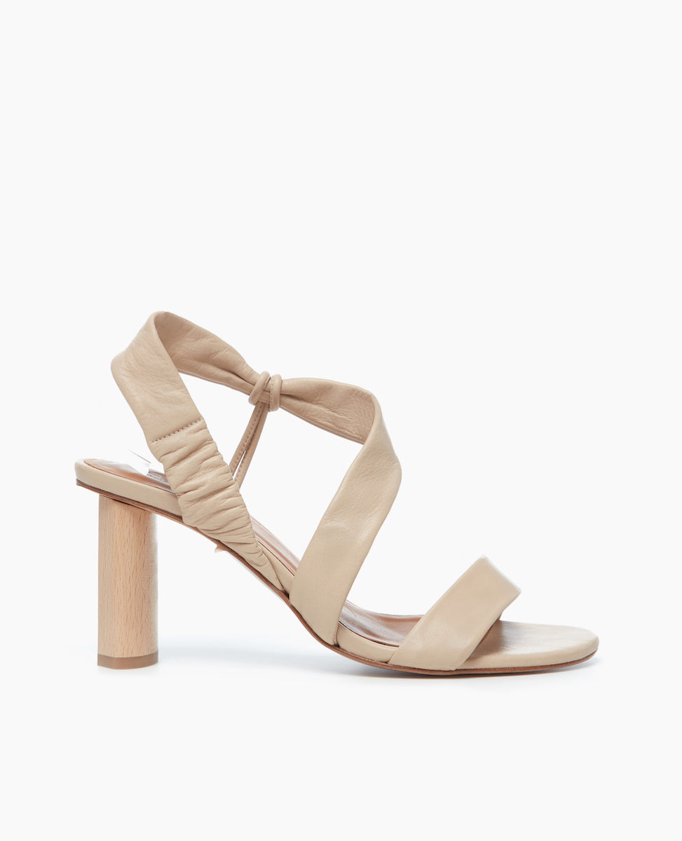 Side view of the Gabby Heel in Latte Macchiato, featuring soft, tubular straps that mold to the foot, one diagonally over the arch in a leg-lengthening magic trick.