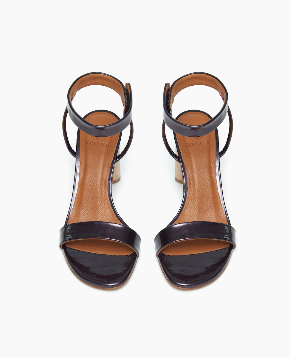Front view of the Gina Heel in Black Pearl Antiqued Patent with a straight, narrow front strap and ankle strap.