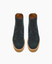 Dark green suede ankle boots with a smooth texture, featuring a round toe, tan rubber sole, and a back zipper closure. 7