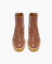 Brown ankle boots with a smooth leather finish, round toes, side zippers, and thick beige rubber soles. 8