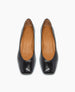 A pair of black leather ballet flats with a smooth, glossy finish, almond-shaped toes, tan insoles, and a subtle logo embossed on the inner sole. 9