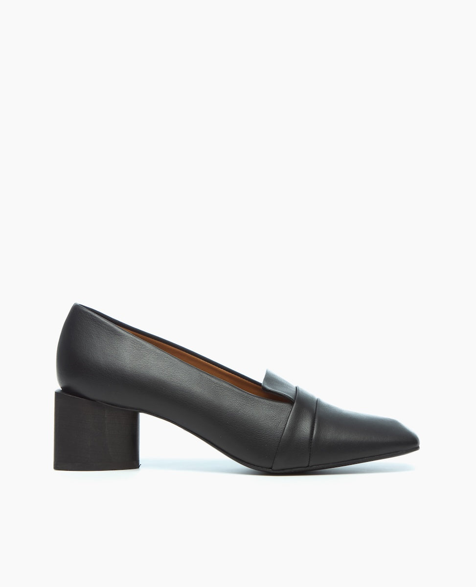 A sleek, black leather loafer with a pointed toe, featuring a low block heel and a smooth, polished finish.