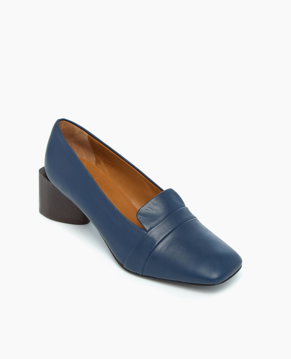 A blue leather loafer with a square toe, a low block heel, and a tan interior lining.