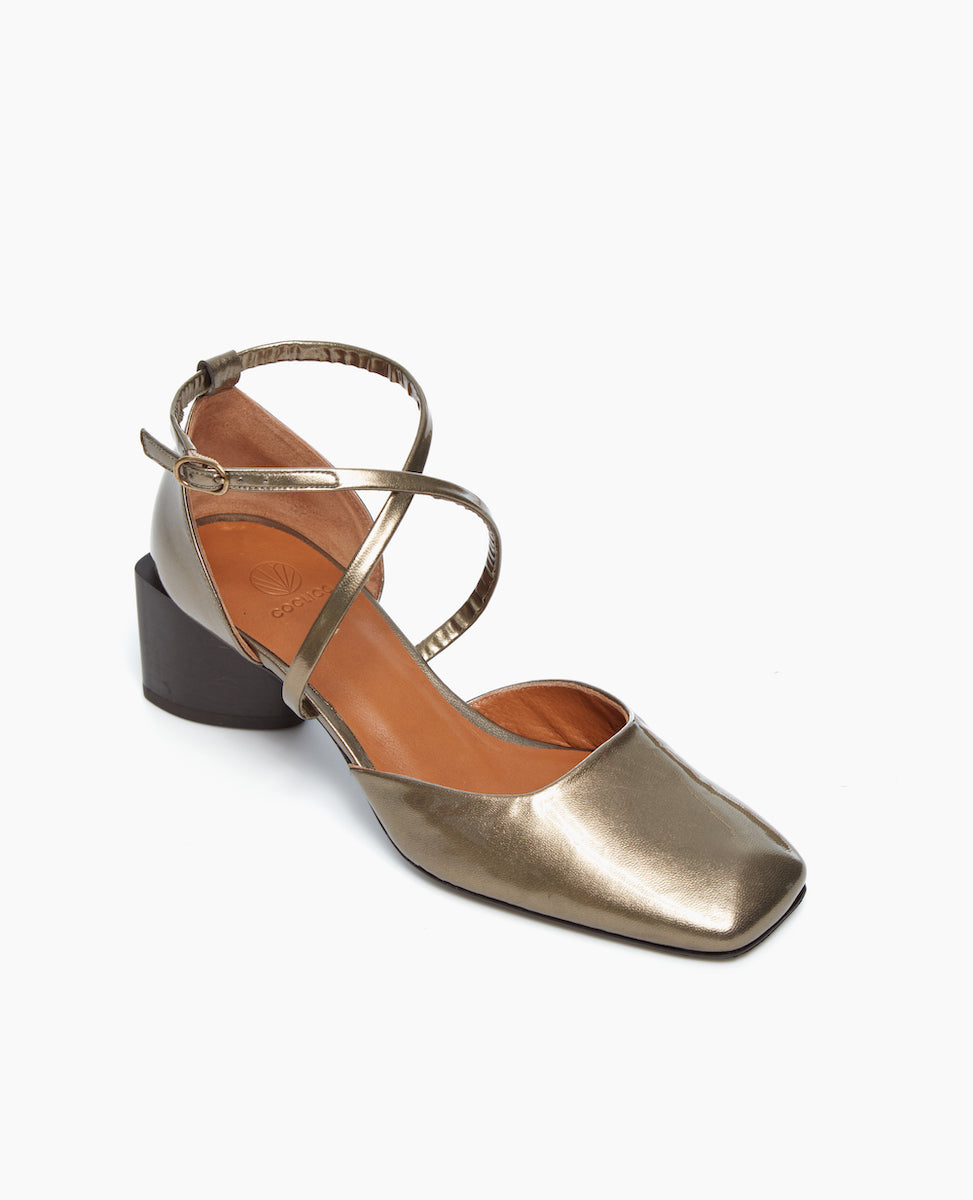 Angled view of the Isabel Mary Jane in Starry Night in patent leather: featuring criss-cross-straps with a sculptural mid-height heel and a squared-off, angular toe character.