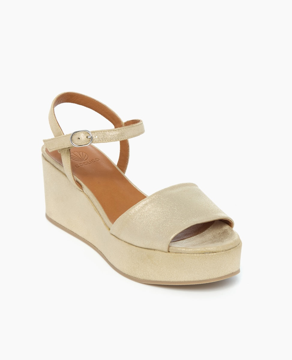 Angled view of the Lauren Wedge in Champagne Shimmer Suede