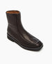 A sleek, dark brown leather ankle boot with a square toe, smooth texture, side zipper, and a sturdy black sole. 6