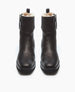 A pair of black leather ankle boots with a smooth texture, squared-off toes, side zippers, and a plush white fur lining visible at the top. 7