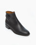 A sleek, black leather ankle boot with a smooth texture, a low block heel, an almond toe, and a side buckle strap detail. 3